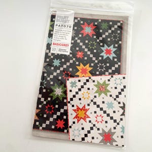 May include: A sewing pattern packet featuring a quilt design with star patterns in red, yellow, green, and blue on a black and white background. The packet is labeled "FRUIT BURST" and "PAT070".