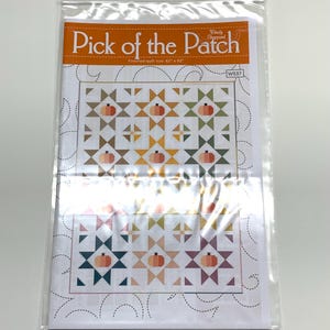May include: A quilting pattern for a quilt called "Pick of the Patch" by Wendy Sheppard. The pattern features a patchwork design with pumpkins and stars in various colors, including orange, yellow, green, blue, and pink. The finished quilt size is 62" x 82".
