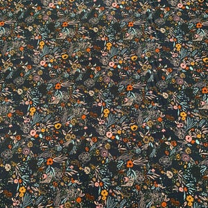 May include: Dark navy fabric with a floral pattern in orange, pink, yellow, and teal. The design includes sketched floral outlines and the text "FORAGED, FOUND & Hand Me Down". The fabric is from the Design House. The fabric is marked with measurements.