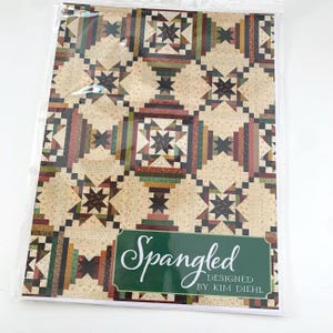 May include: A quilt pattern booklet with a colorful quilt design on the cover. The title of the pattern is "Spangled" designed by Kim Diehl.