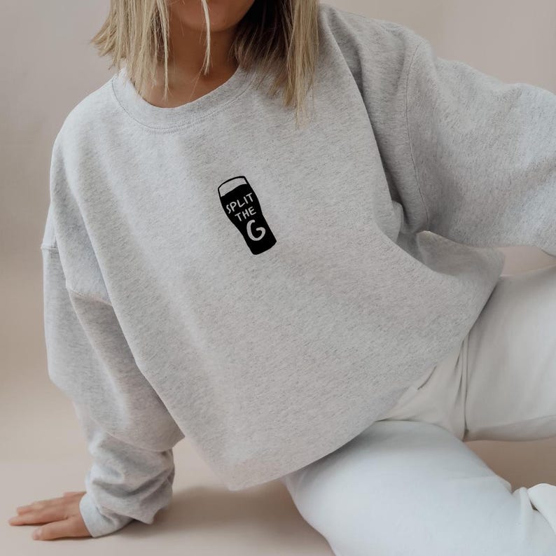 May include: A gray sweatshirt with a black graphic of a pint glass with the text "Split the G" on it.