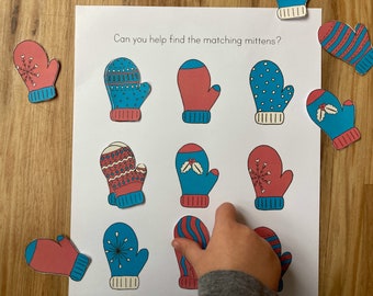 May include: A printable matching game featuring 10 pairs of mittens with different patterns. The mittens are red, blue, and white with snowflake, holly, and striped patterns. The text "Can you help find the matching mittens?" is at the top of the page.