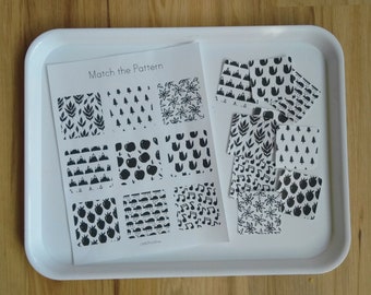 May include: A black and white printable worksheet with the text "Match the Pattern" and nine different patterns to match. The patterns include leaves, trees, flowers, mountains, apples, tulips, musical notes, strawberries, and a geometric pattern.