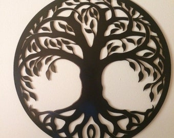 May include: A black metal tree of life wall decor with intricate branches and roots. The design is circular and has a cutout pattern.