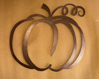 May include: A brown metal pumpkin cutout with a curly stem. The pumpkin is a simple silhouette with a double outline.
