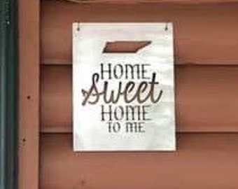 May include: Metal sign with a cutout of the state of Tennessee and the text "Home Sweet Home to Me".