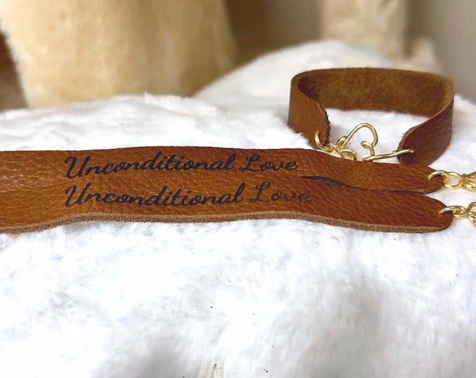 Leather bracelet with wire wrapped heart and engraved message “Unconditional Love"