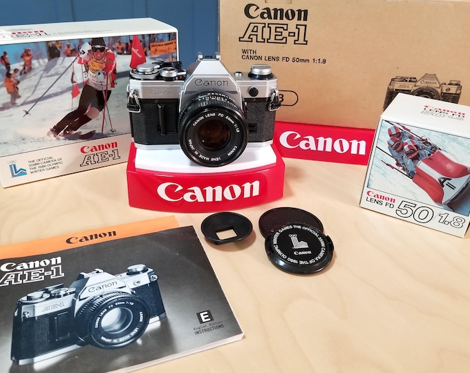 Classic Canon AE-1 35mm SLR Camera 1980 Lake Placid Olympics Set w/ Canon NFD 50mm f/1.8 Lens & Cap - Film Tested, New Battery, Books, Boxes