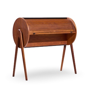 May include: A mid-century modern wooden desk with a roll-top design. The desk features a cylindrical body with a slatted roll-top, supported by angled wooden legs. The wood has a warm, reddish-brown tone.