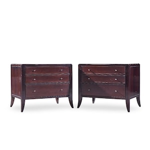 May include: Two matching dark brown wooden dressers with three drawers each. The dressers have a rectangular shape with a dark frame and silver drawer pulls. The legs are slightly curved.