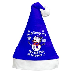 May include: A blue Santa hat with a white brim and a white pom-pom. The hat features a snowman graphic with a red scarf and the text "I'm dreaming of a Ipswich Red and Blue Christmas!"