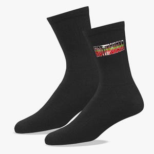 May include: A pair of black crew socks. The socks feature the word "NOTTINGHAM" in white, red, and green lettering. The socks are made of a soft, comfortable material.