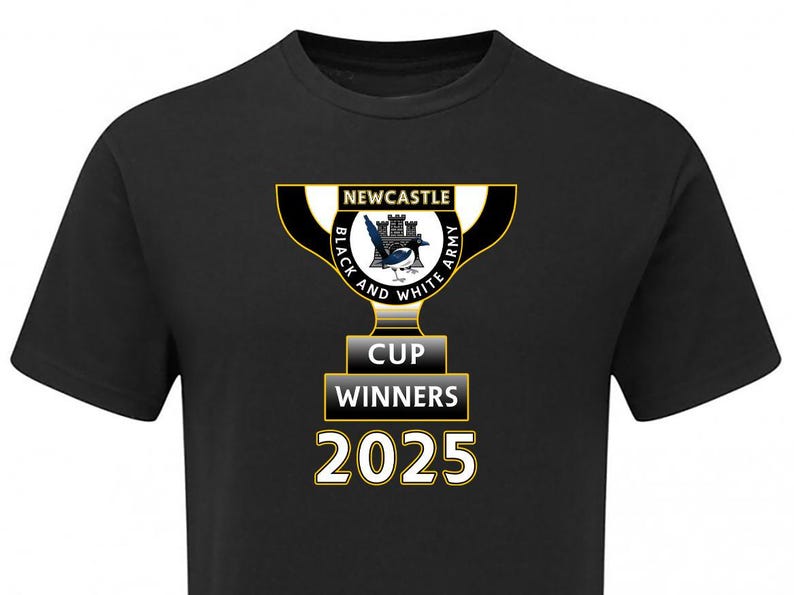May include: Black t-shirt with a trophy design. The text reads "NEWCASTLE BLACK AND WHITE ARMY CUP WINNERS 2025". The trophy is in black, white, and gold, with a magpie emblem. A sports-themed item of clothing.