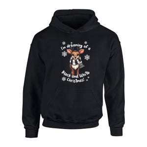 May include: Black hooded sweatshirt featuring a reindeer graphic with a black and white scarf and the text "I'm dreaming of a Black and White Christmas!". The reindeer has antlers and is surrounded by snowflakes.