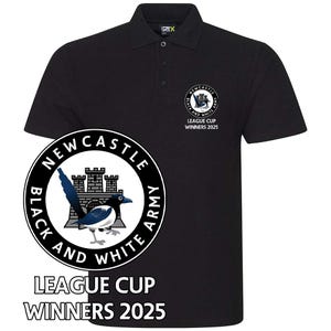 May include: Black polo shirt with a white embroidered logo featuring a castle, a magpie, and the text "Newcastle Black and White Army". The text "League Cup Winners 2025" is also embroidered on the shirt.