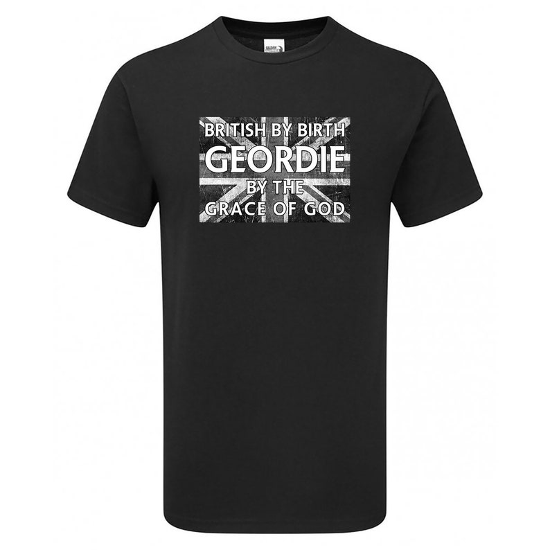 May include: Black t-shirt with a distressed Union Jack graphic. The graphic includes the text "BRITISH BY BIRTH GEORDIE BY THE GRACE OF GOD" in white lettering. The shirt is a crew neck style.