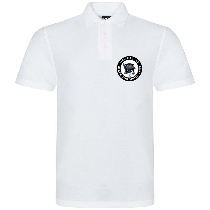 May include: White polo shirt with a black and white circular logo featuring a castle, a bird, and the text "Newcastle Black and White Army".