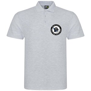 May include: A gray polo shirt with a black and white circular emblem featuring a Newcastle castle and a magpie. The emblem reads "Newcastle Black and White Army".