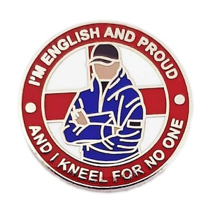 May include: A red, white and blue enamel pin with a cartoon image of a person wearing a blue jacket and a baseball cap. The pin says "I'm English and Proud and I kneel for no one".
