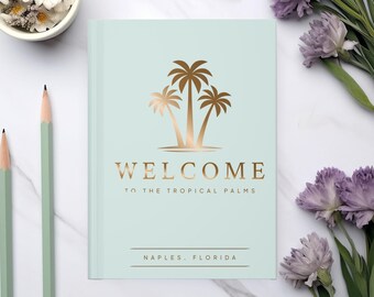 Peut inclure: Un carnet vert clair avec un motif de palmier doré et le texte "WELCOME TO THE TROPICAL PALMS NAPLES, FLORIDA".