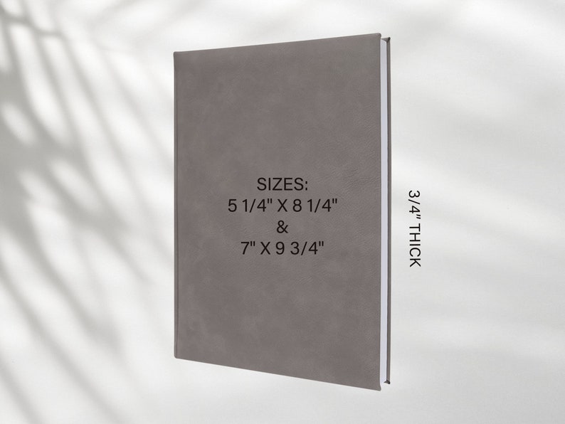 May include: A gray, textured journal with the text "SIZES: 5 1/4" X 8 1/4" & 7" X 9 3/4" 3/4" THICK" printed on the front cover.