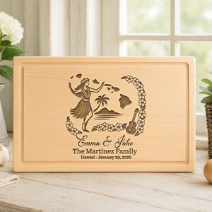 May include: Rectangular wooden cutting board with a carved Hawaiian design. The design includes a hula dancer, palm trees, a guitar, and the text "Emma & Jake The Martinez Family Hawaii - January 29, 2026."