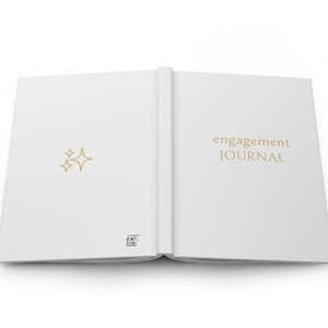 May include: A white engagement journal with the text "engagement JOURNAL" on the cover. The cover also features a small gold star design.