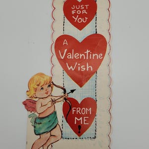 May include: Vintage Valentine's Day card featuring a cherub with a bow and arrow, hearts, and the text "Just for You", "A Valentine Wish", and "From Me".