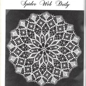 May include: A white crocheted doily with a spider web design. The doily is circular and has a delicate, intricate pattern. The title "Spider Web Doily" is written in cursive above the doily.