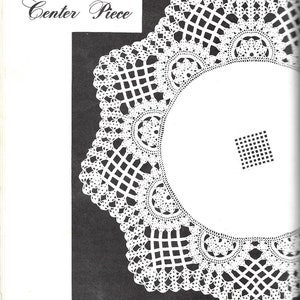 May include: A white crochet doily with a cross-bar center piece. The doily is circular and has a delicate lace pattern. The text "Cross-Bar Center Piece" is printed above the doily.