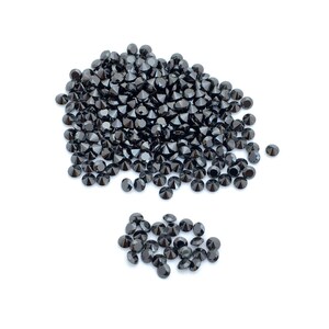 May include: A large pile of black round gemstones, with a smaller pile of black round gemstones to the side.