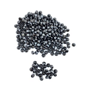 May include: A large pile of black round gemstones, with a smaller pile of black round gemstones to the side.