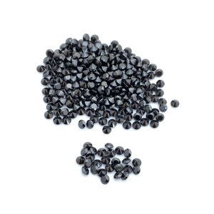 May include: A large pile of black round gemstones, with a smaller pile of black round gemstones to the side.