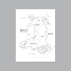 May include: A black and white map of Wales, with the country's name and the names of its counties labeled. The Irish Sea, Cardigan Bay, and Bristol Channel are also labeled. The map is on a white background.