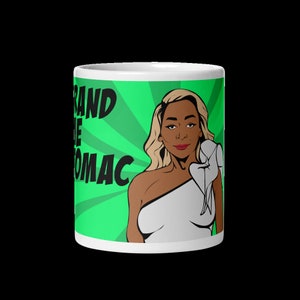 May include: White ceramic mug with a green background and a pop art style illustration of a woman with blonde hair. The text "Grand Dame of Potomac" is printed in black on the mug.