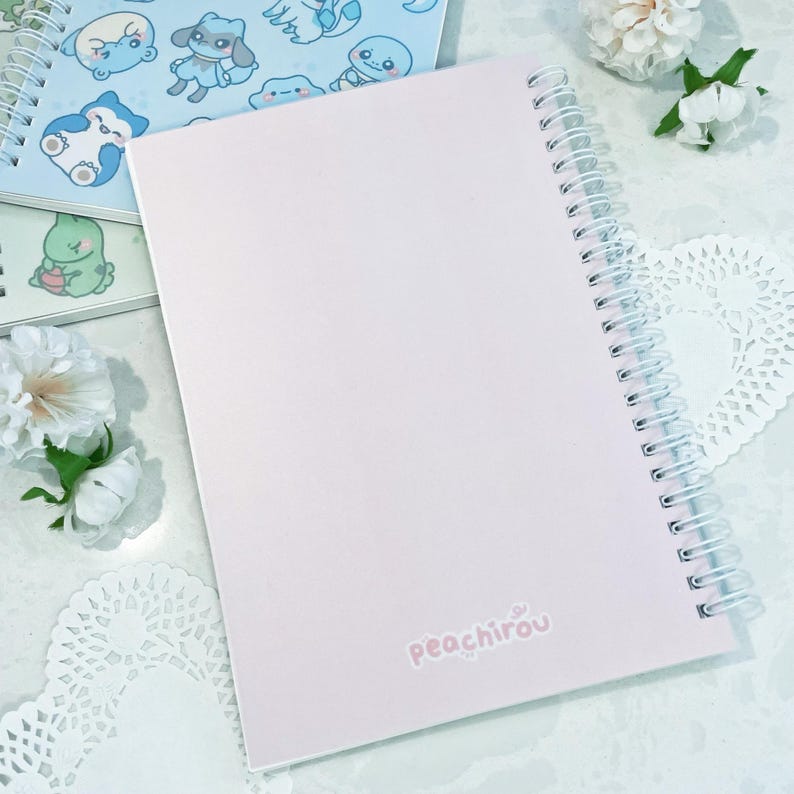 May include: A pink spiral bound notebook with the text "peachirou" printed on the cover.