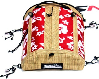 May include: A red and white floral patterned bag with a tan woven base. The bag has a black handle and multiple black straps with clips. The bag has the text "DeckBagZ" printed on the bottom.