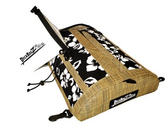 May include: A black and white floral patterned bag with a brown woven fabric panel. The bag has a zipper closure and a black strap with a buckle. The bag has a black drawstring closure and a black logo that says "DeckBagZ Zone".