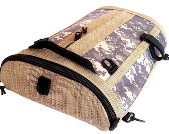 May include: A brown and tan woven backpack with a camouflage pattern on the back. The backpack has a zipper closure and adjustable straps.