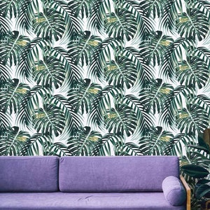 Vibrant monstera leaf pattern wallpaper in a modern living room with an accent sofa.