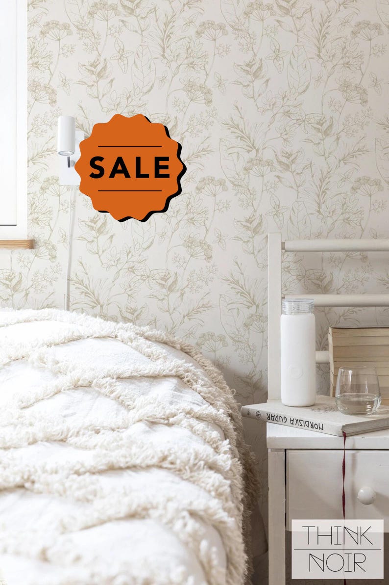 May include: A bedroom scene featuring floral wallpaper and a white bed with a textured comforter. A white nightstand holds a water bottle, books, and a glass. An orange "SALE" tag is visible on the wall. The words "THINK NOIR" are printed on the nightstand.
