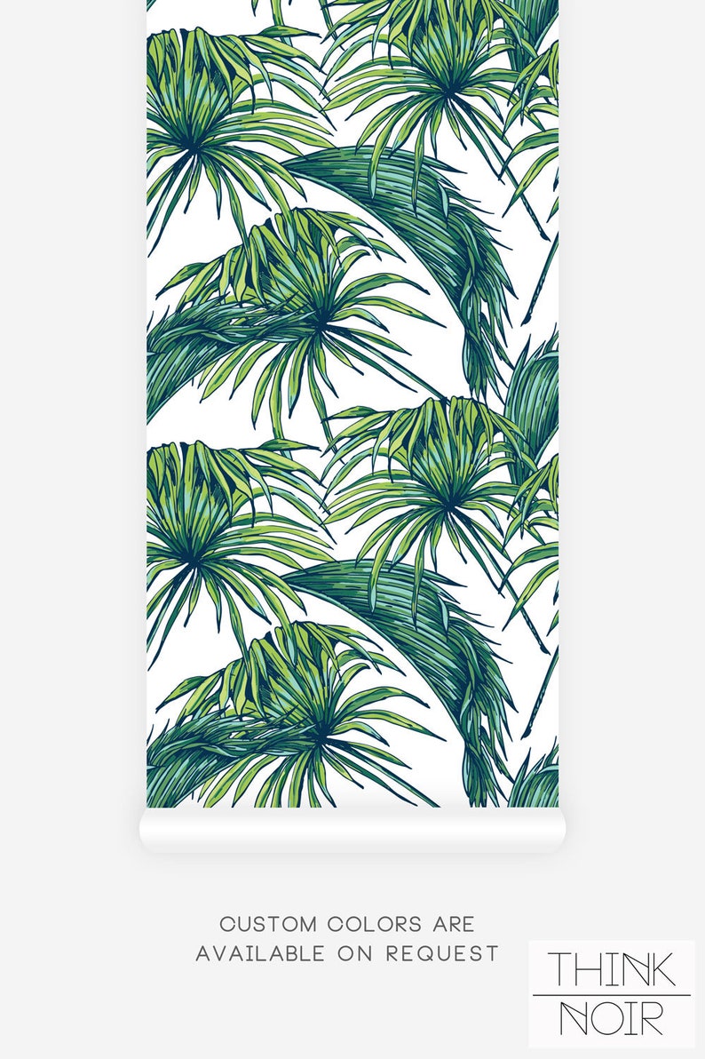 Palm leaves pattern Think Noir wallpaper in green and white.