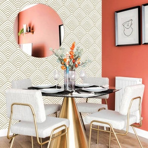 Eclectic dining room interior with a wallpapered accent wall in a geometrical art deco inspired pattern.