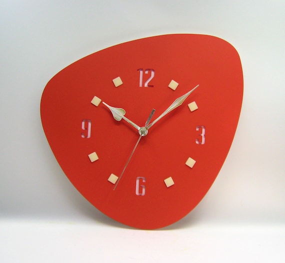 Laser-cut acrylic wall clock with genuine atomic-era starburst aesthetics in burnt sienna — the kind of retro statement piece that anchors a whole room.