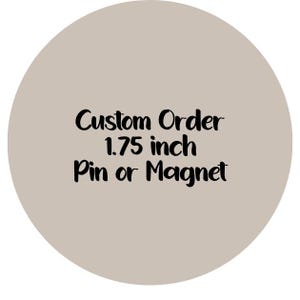 May include: A round, taupe-colored pin or magnet with the text "Custom Order 1.75 inch Pin or Magnet" in black cursive font. The text is centered on the circular object.