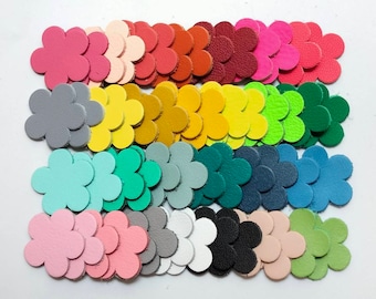 May include: Assortment of colorful leather flower shapes in various colors, including pink, gray, yellow, green, blue, and white.