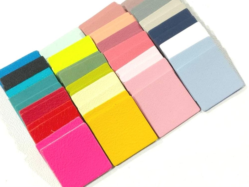 May include: Assortment of 20 small square leather samples in various colors, including pink, yellow, blue, green, red, and white.