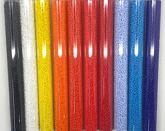 May include: Ten tubes of 11/0 size seed beads in various opaque colors, including black, white, yellow, orange, red, light blue, dark blue, and purple. Each tube contains 30 grams of beads and is labeled with a product number and price.