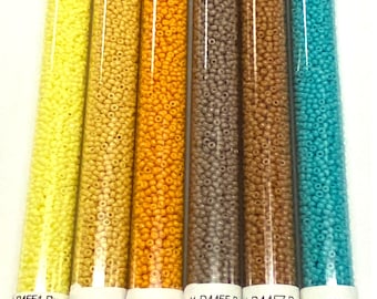 May include: Set of six 11/0 size glass seed beads in various colors, including yellow, orange, brown, and turquoise. Each tube contains 30 grams of beads. The tubes are labeled with the bead size, color, and website address.