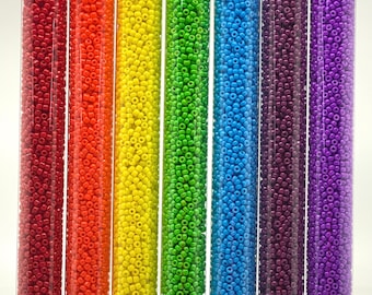 May include: Set of 11/0 size round seed beads in rainbow colors, including red, orange, yellow, green, blue, purple, and dark purple. Each tube contains 30 grams of beads.